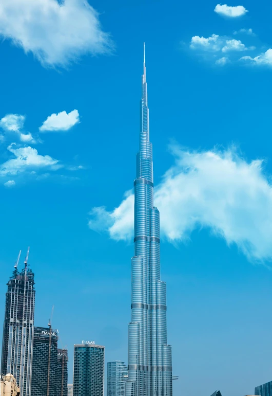 the burjra tower towering over the city of dubai, pexels contest winner, conceptual art, renzo piano, promo image, three - quarter view, tall spires