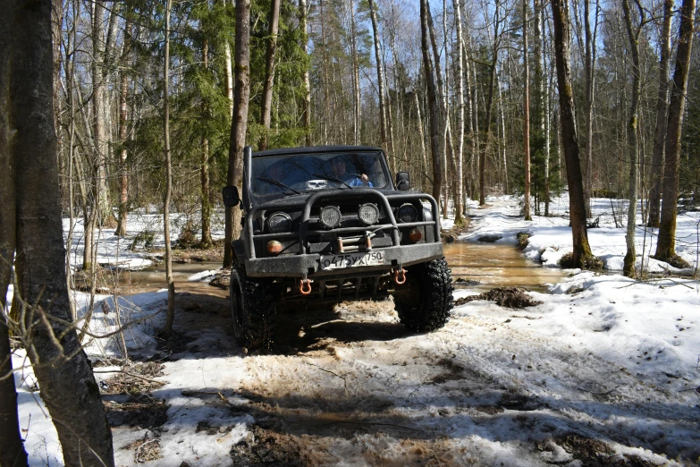 a jeep driving through a snow covered forest, by Veikko Törmänen, unsplash, hurufiyya, covered in mud, square, avatar image, moskvich