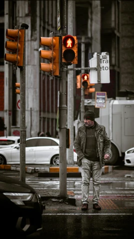 a man walking across a street next to a traffic light, by Tamas Galambos, camo, cold mood, high quality photo, solo male weary soldier