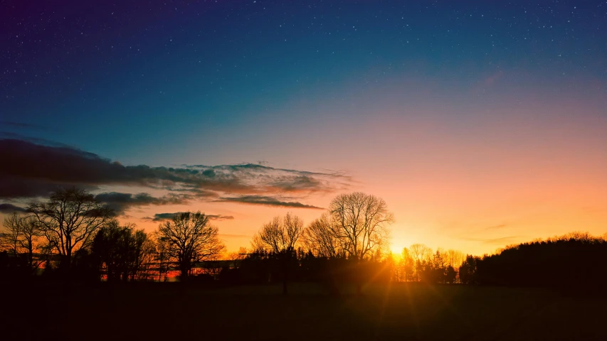 the sun is setting over a field with trees, pexels contest winner, stars filled sky, 1 2 9 7, orange and blue sky, night lights