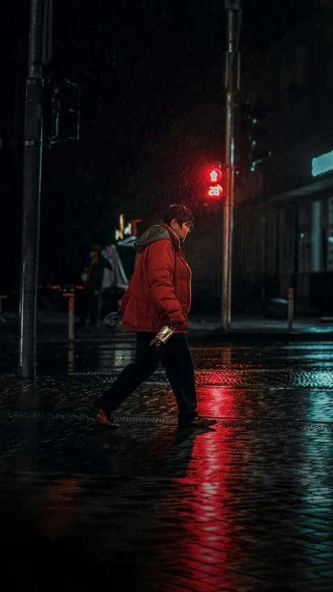 a man walking across a wet street at night, an album cover, unsplash contest winner, wearing red jacket, australian winter night, chillhop, nightlife