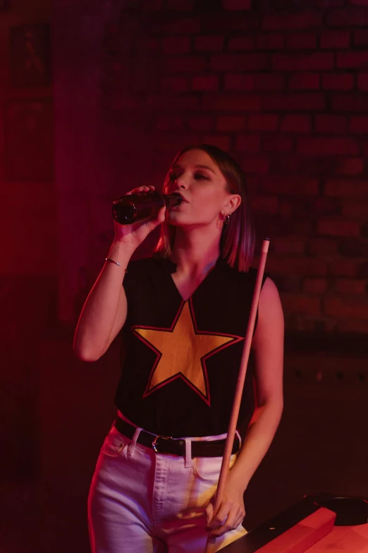 a woman singing into a microphone next to a pool table, pexels, renaissance, aurora aksnes and zendaya, with stars, a dark phoenix, concert photo