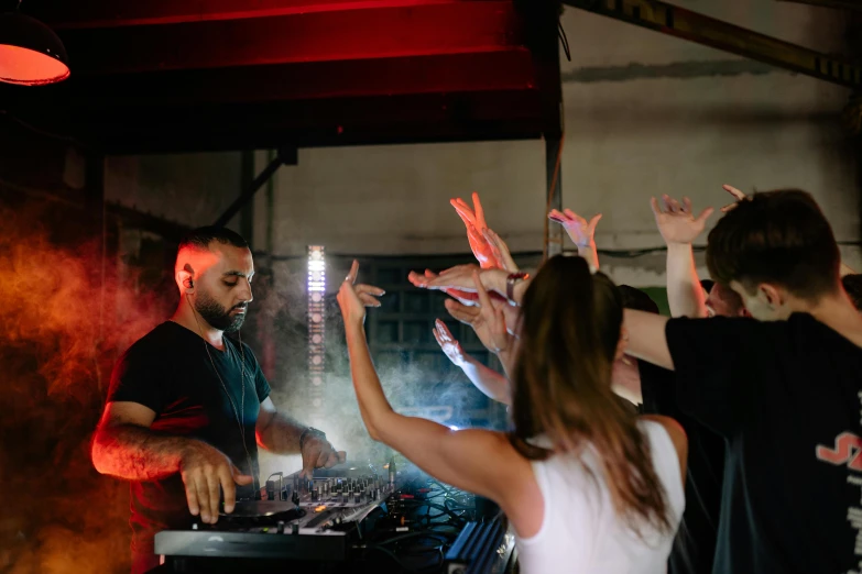 a group of people that are standing in front of a dj, profile image, performing, multiple stories, revellers