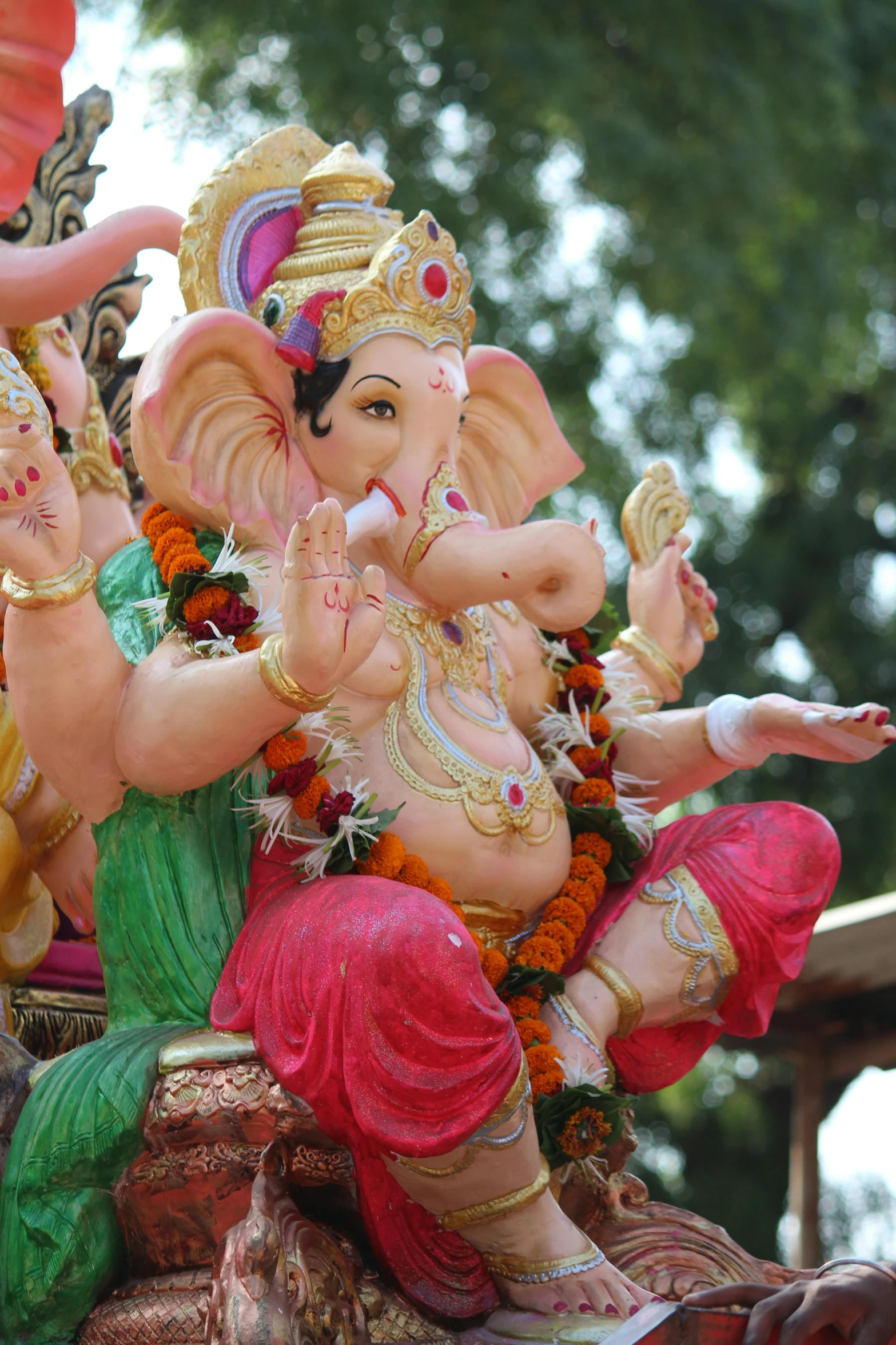 a close up of a statue of an elephant, 3 spring deities, waving, ganesha, ornately dressed