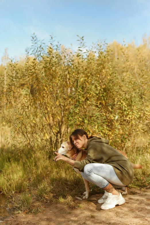 a woman crouches down to pet a dog, by Julia Pishtar, fine art, grassy autumn park outdoor, photography alexey kurylev, movie filmstill, a wild