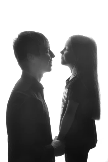 a man and a woman standing next to each other, a black and white photo, pexels contest winner, realism, back lit, profile image, daughter, set against a white background
