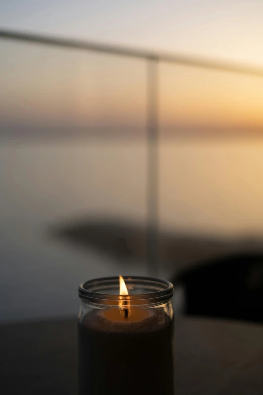 a candle that is sitting on a table, by Niko Henrichon, ocean view, back lit, hero shot, good morning