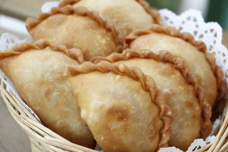 a basket filled with pastries sitting on top of a table, hurufiyya, south east asian with round face, 6 pack, chicken, crisp image