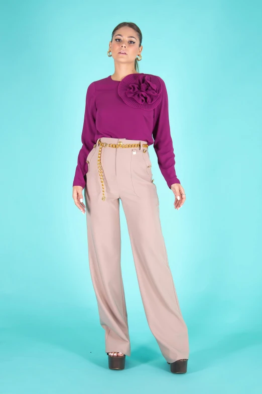 a woman standing in front of a blue background, a colorized photo, purple clothes, large pants, cream colored blouse, detailed product image