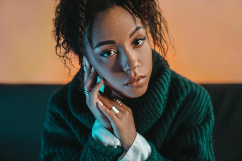 a woman sitting on a couch talking on a cell phone, trending on pexels, hyperrealism, ashteroth, wearing a green sweater, dramatic serious pose, emerald coloured eyes