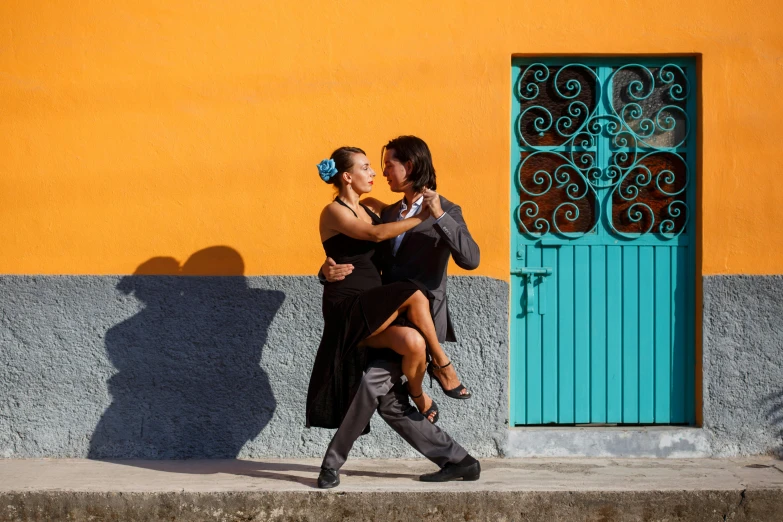 a couple of people that are walking down the street, pexels contest winner, arabesque, orange and turquoise, chilean, couple dancing, square