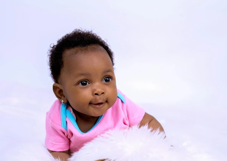 a baby that is laying down with a teddy bear, by Chinwe Chukwuogo-Roy, pexels contest winner, pink white turquoise, looking to his side, plain background, african american young woman