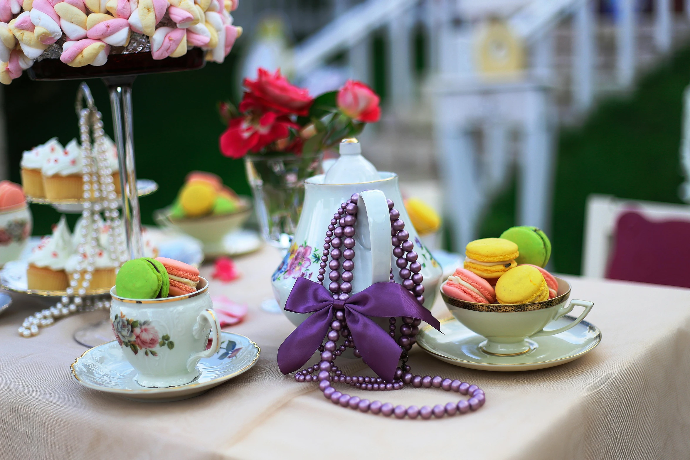 a table topped with lots of different types of food, a portrait, by Alice Mason, unsplash, rococo, purple ribbons, macaron, at the terrace, alice in the wonderland