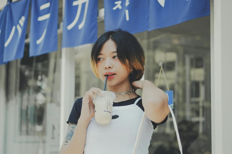 a woman standing in front of a store holding a drink, inspired by Leng Mei, pexels contest winner, shin hanga, wearing tanktop, milk and mocha style, profile image, of taiwanese girl with tattoos