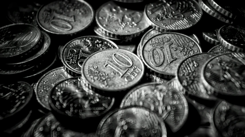 a pile of coins sitting on top of each other, a black and white photo, by Adam Marczyński, pexels, renaissance, gleaming silver, australian, chiaroscuro!!, beware the ides of march