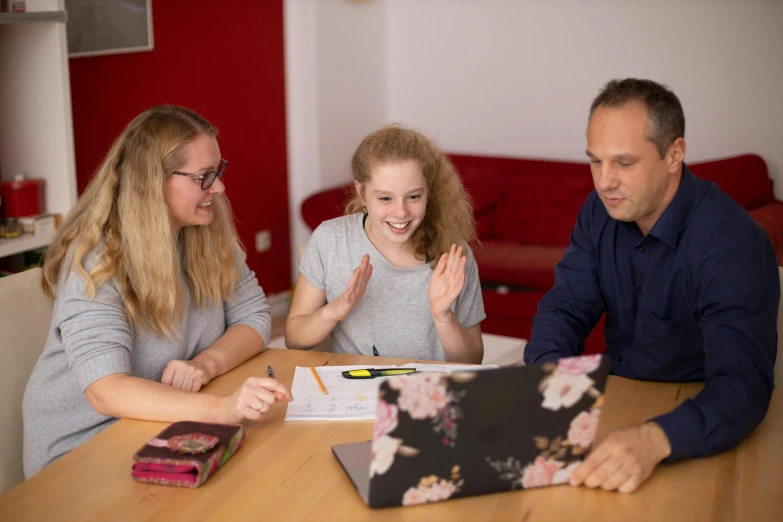 a man and two women sitting at a table with a laptop, pexels contest winner, danube school, avatar image, eldenring, family friendly, high resolution image