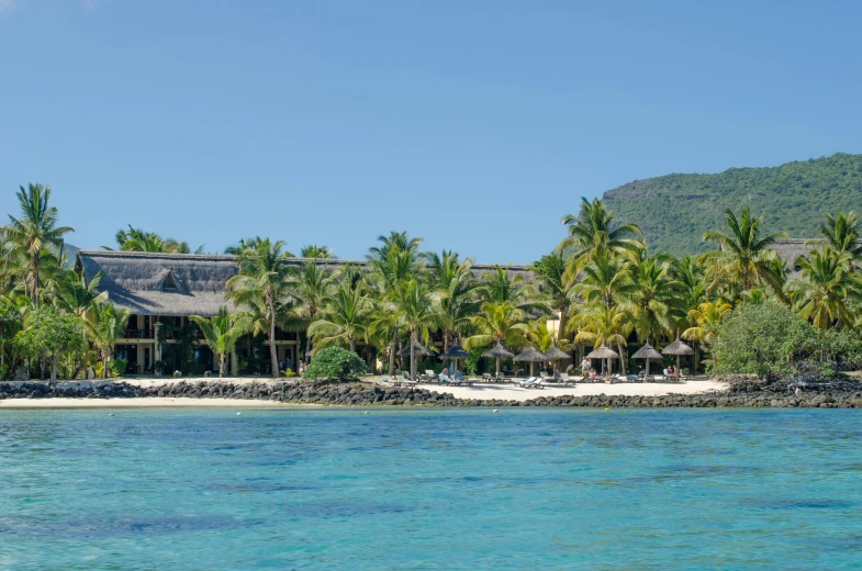 a view of a resort from the water, a photo, inspired by Gaugin, white sand beach, listing image, paradisiac, exterior photo