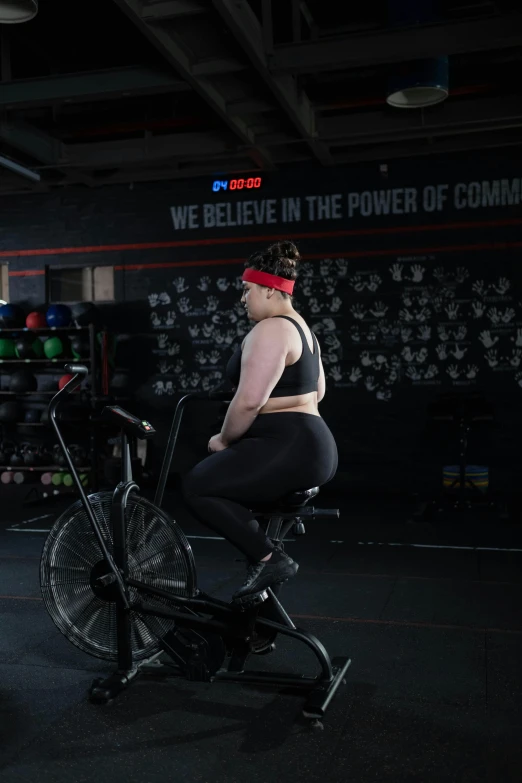 a woman sitting on a stationary bike in a gym, featured on reddit, renaissance, bbwchan, compression, profile image, lachlan bailey