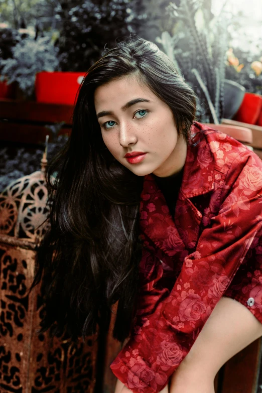 a woman in a red dress sitting on a chair, an album cover, trending on pexels, hurufiyya, beautiful young himalayan woman, a handsome, gif, islamic