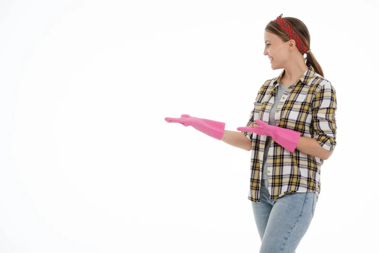 a woman in a plaid shirt holding a pink glove, pexels, plasticien, majestic sweeping action, on a white background, promotional image, looking happy