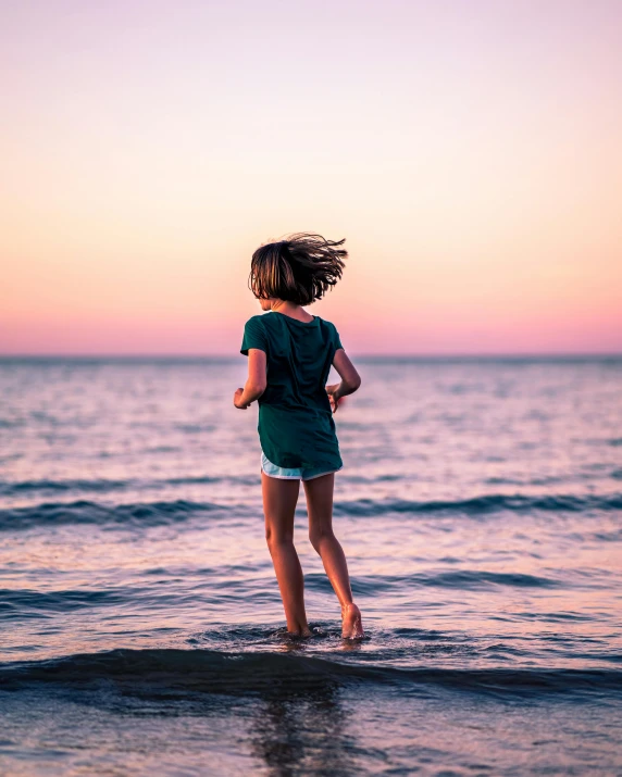 a little girl that is standing in the water, pexels contest winner, happening, trailing off into the horizon, lgbtq, early evening, (beautiful) girl