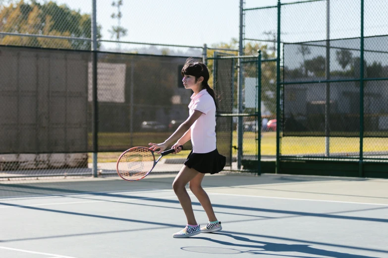 a young girl holding a tennis racquet on a tennis court, unsplash, american barbizon school, action shots, full body image, thumbnail, shot on sony a 7