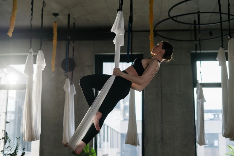 a woman hanging upside down on a hammock, by Emma Andijewska, arabesque, dingy gym, square, full body 8k, profile image