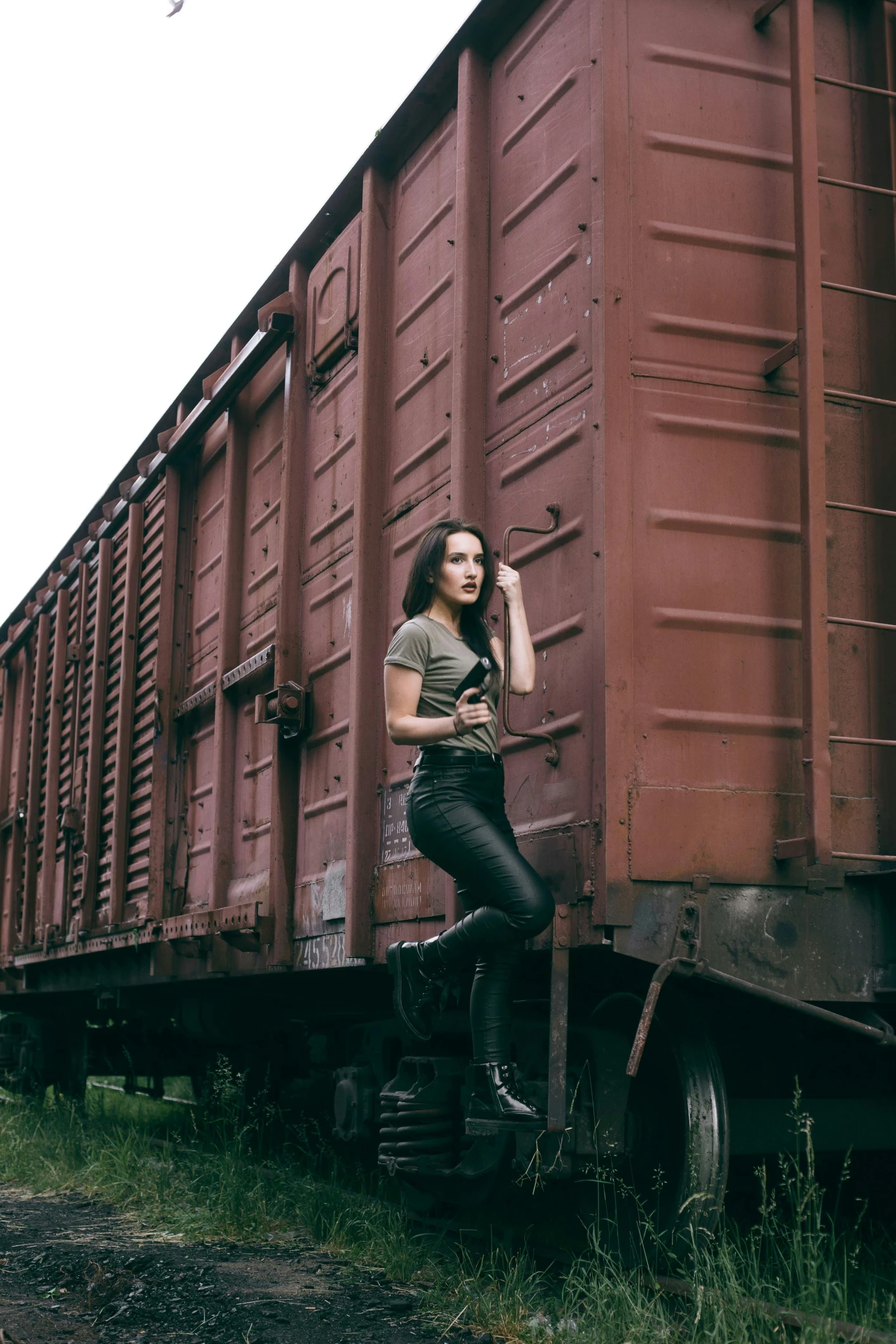 a woman sitting on the side of a train, a portrait, by Lucia Peka, pexels contest winner, soviet yard, full body model, leathery, 🚿🗝📝