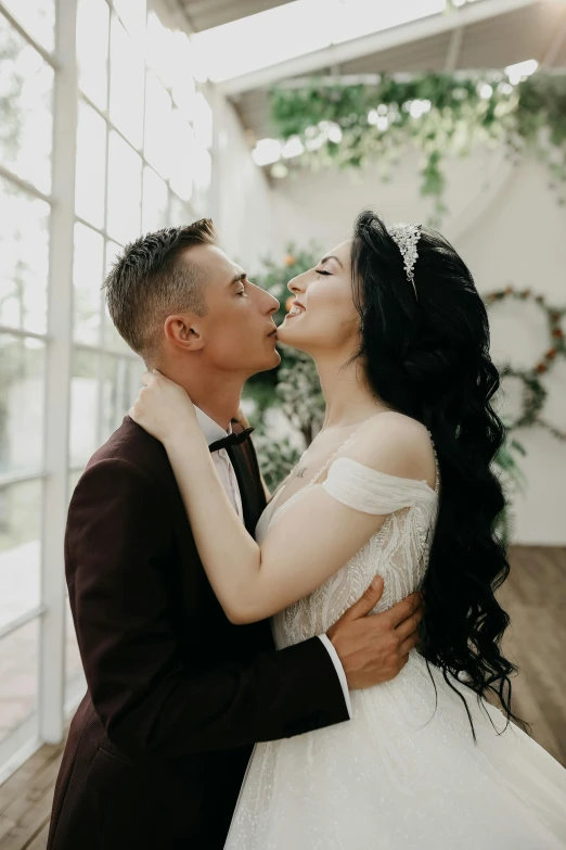 a man in a tuxedo kissing a woman in a wedding dress, pexels contest winner, thumbnail, enhanced quality, natural light in room, with a crown