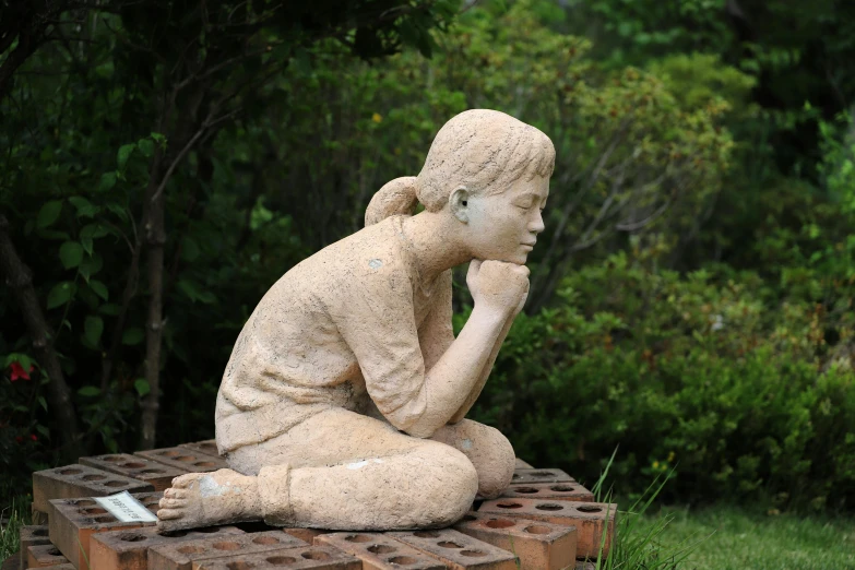 a statue of a woman sitting on a block, inspired by Naka Bokunen, concrete art, looking sad, in a garden, aged 13, ((tatsuro yamashita))