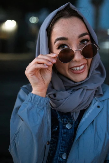 a close up of a person wearing sunglasses, inspired by Modest Urgell, hurufiyya, grey clothes, excited, modelling, middle eastern
