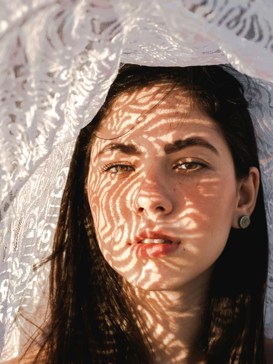 a woman standing under a white lace covered umbrella, pexels contest winner, hyperrealism, perfectly shaded face, in rays of sunlight, young middle eastern woman, young glitched woman