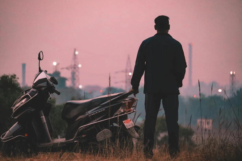 a man standing next to a motorcycle in a field, pexels contest winner, lone silhouette in the distance, looking at the city, moped, plain background