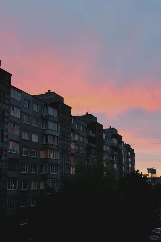 a couple of tall buildings sitting next to each other, inspired by Elsa Bleda, unsplash contest winner, aestheticism, soviet suburbs, late summer evening, low quality photo, pink clouds in the sky