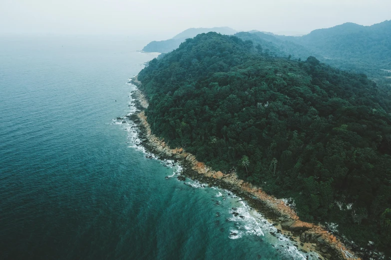 a small island in the middle of the ocean, by Daniel Lieske, pexels contest winner, sumatraism, lush forests, coastal cliffs, alessio albi, manly