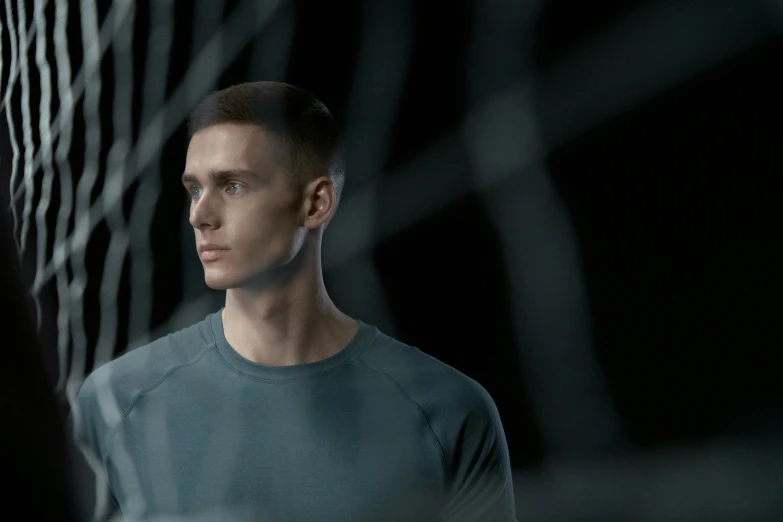 a man standing in front of a fence, inspired by Jakub Husnik, pexels contest winner, hyperrealism, in a dark futuristic room, 3 d demo reel avatar, wearing adidas clothing, group of people in a dark room