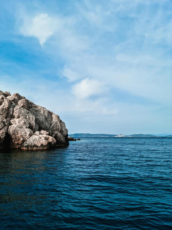 a large rock in the middle of a body of water, pexels contest winner, croatian coastline, slide show, byzantine, enhanced photo