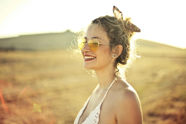 a woman wearing sunglasses standing in a field, pexels, happening, hair jewellery, large smile, avatar image, half - length photo