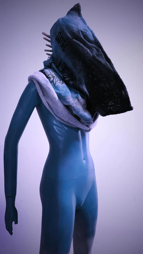 a close up of a mannequin wearing a shark mask, an album cover, by Liza Donnelly, unsplash, new sculpture, black and blue and purple scheme, hooded cowl, fine cyborg lace, volumetric wool felting