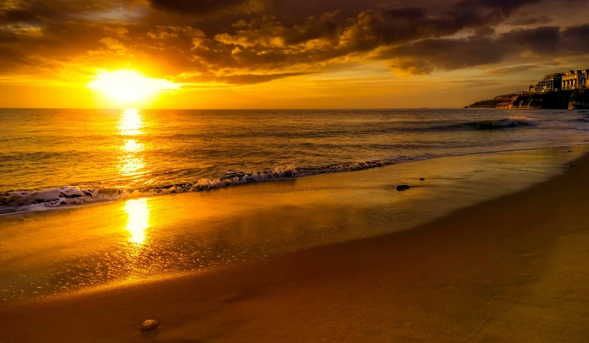 the sun is setting over the ocean on the beach, pexels contest winner, yellow colors, kauai, slide show, gold