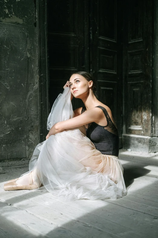 a woman sitting on the ground with a veil over her head, a portrait, by Elizabeth Polunin, pexels contest winner, arabesque, candid photo of gal gadot, in doors, wearing a tutu, 15081959 21121991 01012000 4k