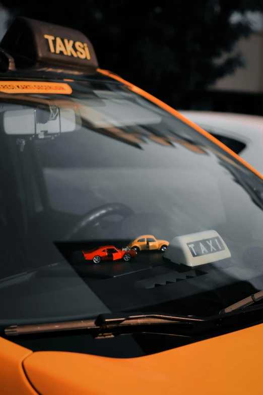 a close up of a taxi cab on a city street, by Sven Erixson, unsplash, orange balaclava, square, tiny details, mclaren f1