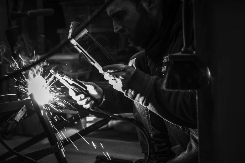 a black and white photo of a welder, by Kristian Zahrtmann, pexels contest winner, arbeitsrat für kunst, wrought iron, restomod, teaser, small manufacture