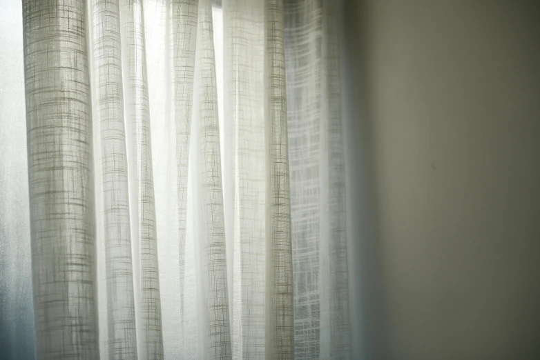 a cat sitting on top of a bed next to a window, an etching, inspired by Lewis Henry Meakin, unsplash, light and space, soft translucent fabric folds, silver，ivory, vertical lines, lined in cotton