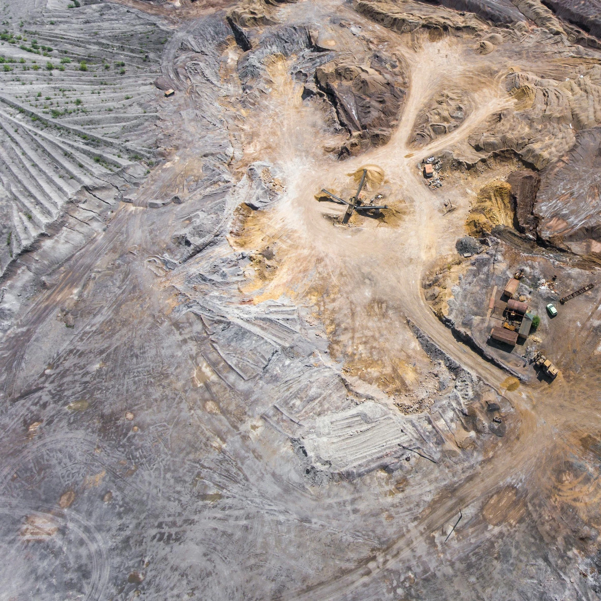 an aerial view of a large open pit, a portrait, unsplash, dust clouds and building debris, “diamonds, geological strata, mx2