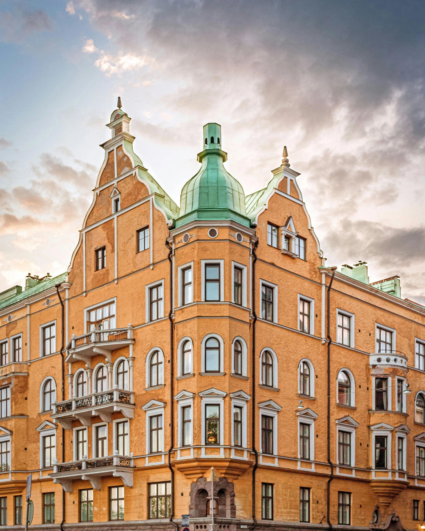 a large brick building with a green roof, by Constantin Hansen, pexels contest winner, art nouveau, nordic crown, thumbnail, lgbtq, cover image