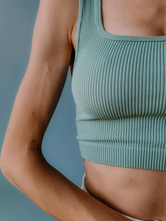 a close up of a person wearing a crop top, by Carey Morris, trending on pexels, sage green, skinny upper arms, ((greenish blue tones)), cottagecore!! fitness body