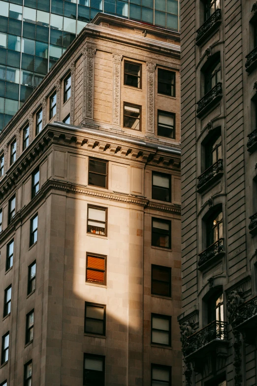 a tall building sitting in the middle of a city, unsplash contest winner, modernism, soft sunlight dappling, 1910s architecture, wall street, boston