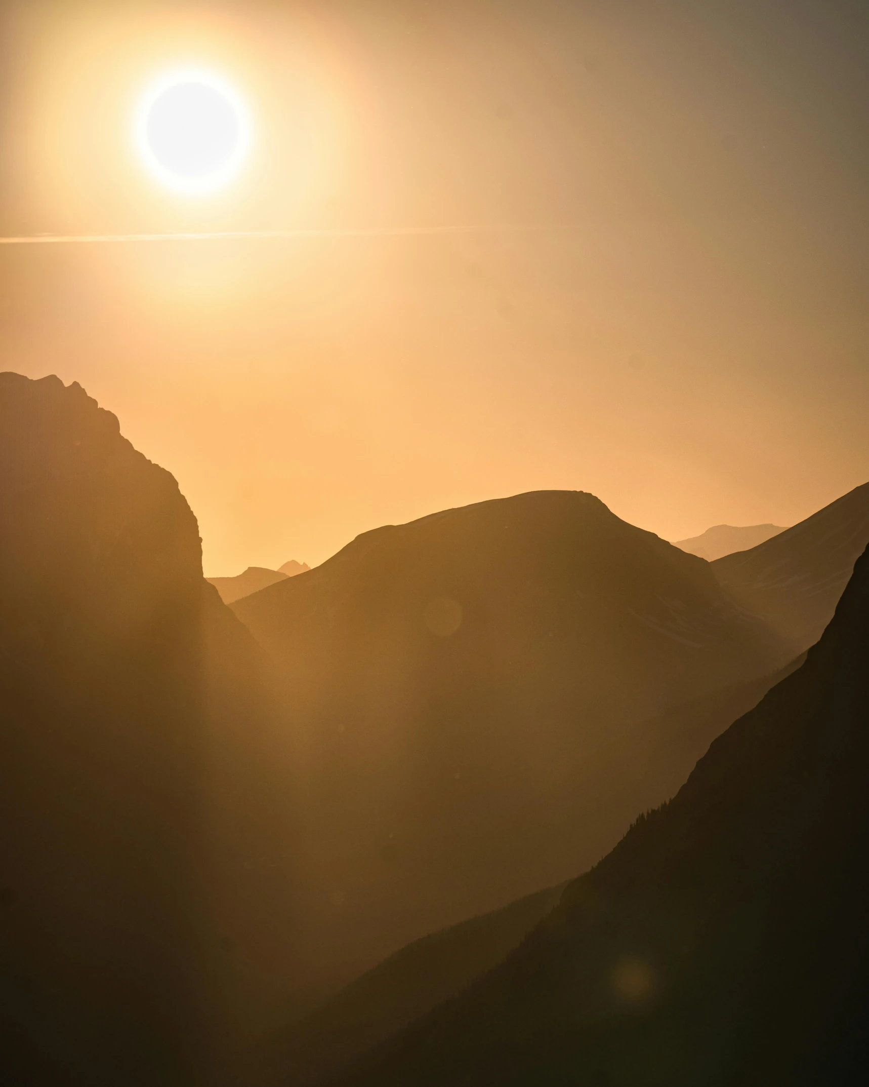 a couple of people standing on top of a mountain, by Sebastian Spreng, pexels contest winner, romanticism, sun rises between two mountains, shafts of sunlight in the centre, in between a gorge, telephoto shot