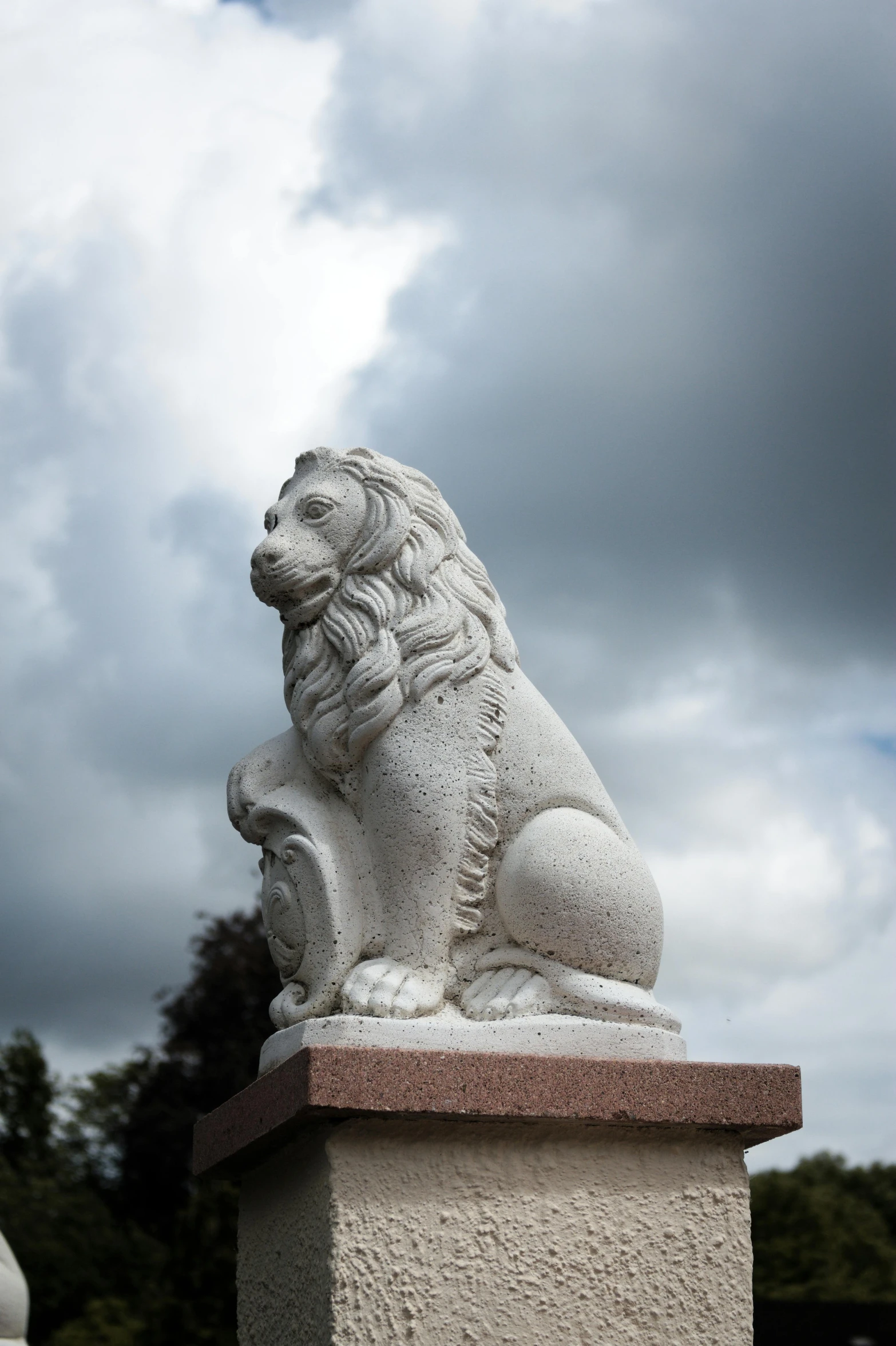 a statue of a lion sitting on top of a pillar, looking off into the distance, lynn skordal, carrington, white stone